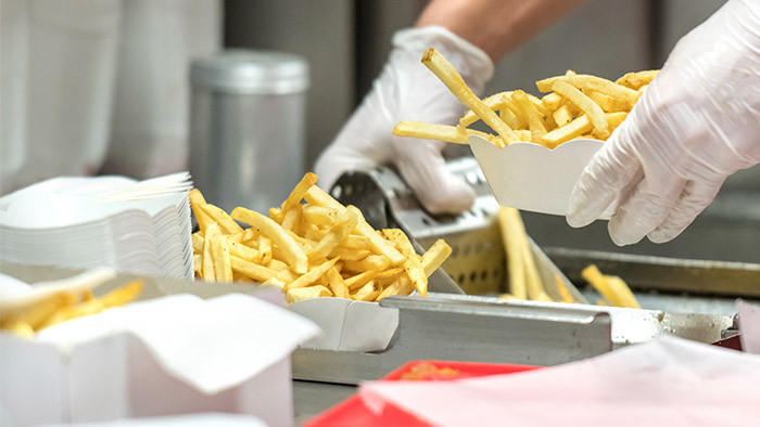 Restaurant worker preparing french fries