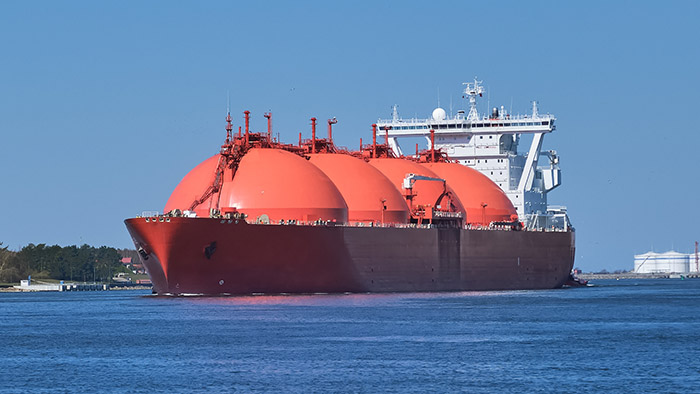 Liquefied natural gas carrier with spherical storage tanks sailing near shore